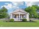 Charming home featuring a cozy front porch with a white picket fence and neatly landscaped yard at 2025 E Broadway St, Fortville, IN 46040