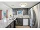 Bright and modern kitchen with updated appliances, granite countertops, and wood flooring at 2025 E Broadway St, Fortville, IN 46040