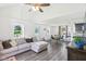 Open-concept living room featuring a sectional sofa and seamless flow to the dining area and kitchen at 2025 E Broadway St, Fortville, IN 46040