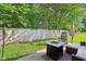 A cozy patio area with a modern gas fire pit, comfortable seating, and lush greenery, perfect for outdoor relaxation at 2025 E Broadway St, Fortville, IN 46040