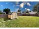 Large backyard with a wooden fence and a storage shed at 2154 Barth Ave, Indianapolis, IN 46203