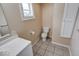 Simple bathroom with a single vanity, standard toilet, and tiled floors at 2154 Barth Ave, Indianapolis, IN 46203