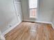 Bedroom with a closet, light walls, a window letting in natural light, and wood floors at 2154 Barth Ave, Indianapolis, IN 46203
