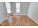 Bright bedroom featuring hardwood floors and two windows, offering ample natural light at 2154 Barth Ave, Indianapolis, IN 46203