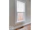 Bedroom view of a window with a white frame, letting in soft light on the wood floor at 2154 Barth Ave, Indianapolis, IN 46203