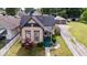 Well-maintained home with a covered front porch, vibrant landscaping, and a detached garage at 2154 Barth Ave, Indianapolis, IN 46203