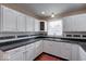 White cabinets, dark counters, and a stylish backsplash adorn this updated kitchen space at 2154 Barth Ave, Indianapolis, IN 46203
