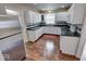 Bright kitchen features white cabinets, stainless steel refrigerator, and modern appliances at 2154 Barth Ave, Indianapolis, IN 46203
