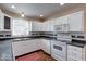This stylish kitchen features white appliances, modern countertops and backsplash and recessed lighting at 2154 Barth Ave, Indianapolis, IN 46203