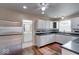 The bright kitchen features stainless steel appliances, sleek counter tops and a view of the bathroom at 2154 Barth Ave, Indianapolis, IN 46203