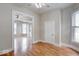 Bright living room with connecting rooms, wood floors, and white trim and baseboards at 2154 Barth Ave, Indianapolis, IN 46203
