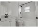 Bright bathroom featuring modern fixtures, a shower-tub combo, and sleek tile flooring at 2344 N Leland Ave, Indianapolis, IN 46218