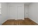 A bright bedroom featuring two closets, an exterior door, and hardwood floors at 2344 N Leland Ave, Indianapolis, IN 46218