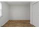 Bedroom featuring hardwood floors, clean walls, and a closet with natural light from the window at 2344 N Leland Ave, Indianapolis, IN 46218