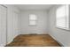 Cozy bedroom with pristine walls, hardwood floors, and a bright window with natural light at 2344 N Leland Ave, Indianapolis, IN 46218