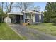Home featuring a covered carport and a well-maintained front yard with a concrete driveway at 2344 N Leland Ave, Indianapolis, IN 46218