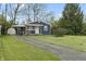 Inviting home featuring a neatly kept lawn, driveway, and charming curb appeal at 2344 N Leland Ave, Indianapolis, IN 46218