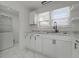 An updated kitchen with a view into the laundry room featuring stainless fixtures and appliances at 2344 N Leland Ave, Indianapolis, IN 46218