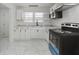 The kitchen features white cabinets and backsplash with stainless steel appliances at 2344 N Leland Ave, Indianapolis, IN 46218