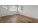 Well-lit living room showcasing gleaming hardwood floors, pristine walls, and a bright window at 2344 N Leland Ave, Indianapolis, IN 46218