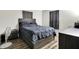Comfortable bedroom featuring a large bed with dark bedding, side table, and dresser, creating a relaxing retreat at 2726 Dawson St, Indianapolis, IN 46203