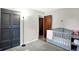 Charming Bedroom with a grey crib, black closets, and a calming atmosphere, creating a safe and comfortable space for your baby at 2726 Dawson St, Indianapolis, IN 46203