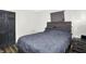 Comfortable bedroom with a gray bed set, dark-wood accents, and closet at 2726 Dawson St, Indianapolis, IN 46203