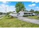 A single-story home with a detached garage featuring a well-maintained lawn and driveway at 2726 Dawson St, Indianapolis, IN 46203