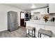 Bright kitchen with stainless steel appliances, white cabinets, and marble countertops, complete with a breakfast bar at 2726 Dawson St, Indianapolis, IN 46203
