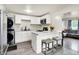 Modern kitchen design featuring white cabinets, a breakfast bar, and stainless steel appliances, creating a stylish and functional space at 2726 Dawson St, Indianapolis, IN 46203