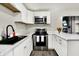 Modern kitchen featuring stainless steel appliances, white cabinets, and sleek countertops at 2726 Dawson St, Indianapolis, IN 46203