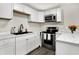 Newly renovated kitchen with stainless steel appliances, white cabinets, and sleek countertops at 2726 Dawson St, Indianapolis, IN 46203