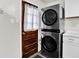 Conveniently stacked washer and dryer next to a wooden door in a well-lit laundry area at 2726 Dawson St, Indianapolis, IN 46203