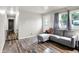 Open-concept living room with hardwood floors, a comfortable gray couch, and a view of the hallway at 2726 Dawson St, Indianapolis, IN 46203