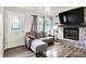 Cozy living room featuring hardwood floors, a brick fireplace, and a comfortable gray sectional couch at 2726 Dawson St, Indianapolis, IN 46203