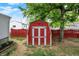 A red and white storage shed is in the backyard of this home at 2726 Dawson St, Indianapolis, IN 46203