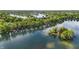 Breathtaking aerial view showcasing a community on the lake, lush greenery, and tranquil waters at 3602 Bay Rd S Dr, Indianapolis, IN 46240