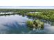Aerial view of lake community, with lush greenery and tranquil waters, captures the essence of peaceful lakeside living at 3602 Bay Rd S Dr, Indianapolis, IN 46240