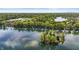 Scenic aerial view capturing the picturesque lake, lush trees, and an island at 3602 Bay Rd S Dr, Indianapolis, IN 46240