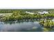 Stunning aerial view of the lake, surrounding wooded areas, and waterfront homes at 3602 Bay Rd S Dr, Indianapolis, IN 46240