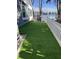 Backyard featuring artificial turf, a white fence, and a view of the lake at 3602 Bay Rd S Dr, Indianapolis, IN 46240