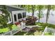 Backyard with a wooden deck, white picket fence, and stairway leading to the water at 3602 Bay Rd S Dr, Indianapolis, IN 46240