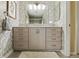 Bathroom vanity with lots of storage, a large mirror and decorative wallpaper at 3602 Bay Rd S Dr, Indianapolis, IN 46240