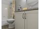 Bathroom featuring a toilet, tiled shower, and vanity with modern fixtures at 3602 Bay Rd S Dr, Indianapolis, IN 46240