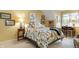 Bedroom with a floral patterned bed, a desk, and multiple framed pictures at 3602 Bay Rd S Dr, Indianapolis, IN 46240