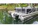 Rear view of a modern Bennington boat docked on a lake with ladders for easy access to the water at 3602 Bay Rd S Dr, Indianapolis, IN 46240