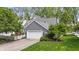 Lovely house exterior with lush trees, a white fence, and a well-kept lawn at 3602 Bay Rd S Dr, Indianapolis, IN 46240