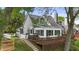 View of house with deck, stairs, and walkway with manicured landscaping and mature trees at 3602 Bay Rd S Dr, Indianapolis, IN 46240
