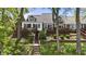 Rear exterior view of home featuring decks, steps to the lake, and landscaped backyard at 3602 Bay Rd S Dr, Indianapolis, IN 46240