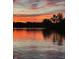 Breathtaking orange sunset reflected on the lake's surface with trees silhouetted nearby at 3602 Bay Rd S Dr, Indianapolis, IN 46240